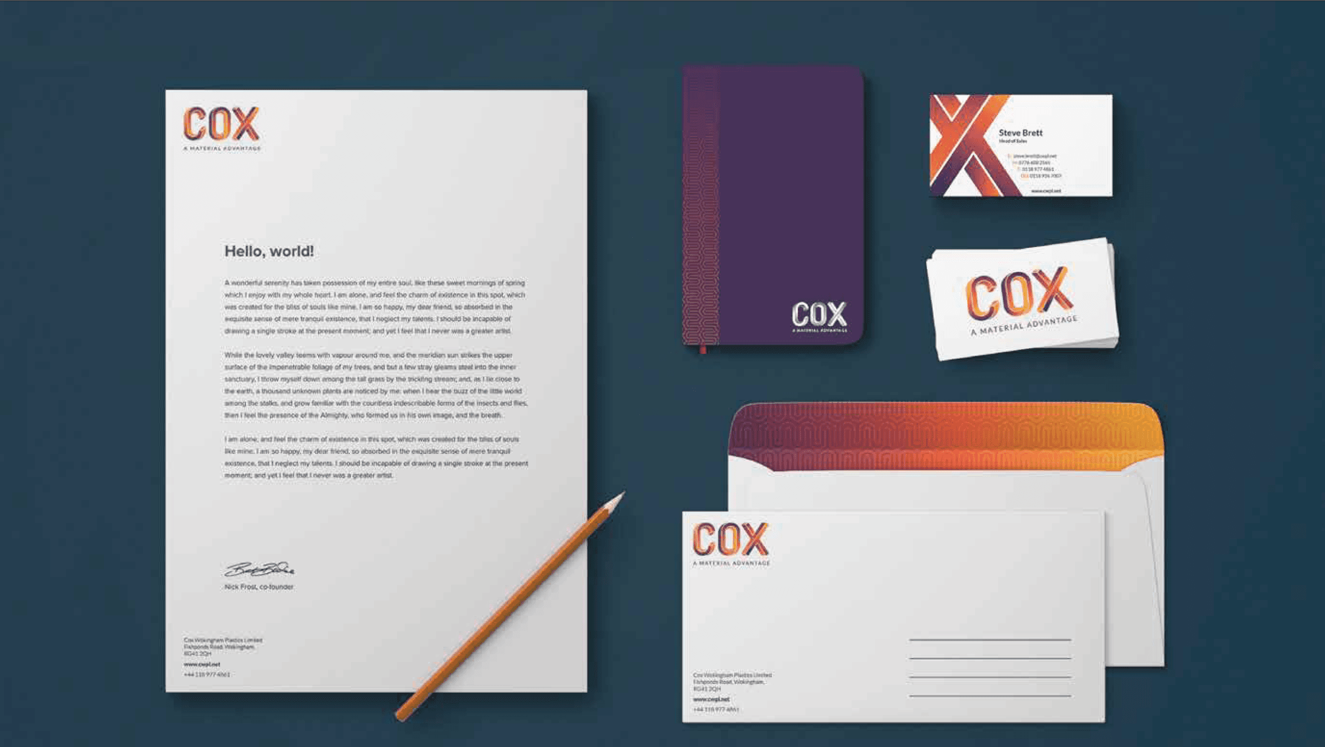 COX branded stationery set including letterhead, notebook, business cards, and envelopes on dark blue.
